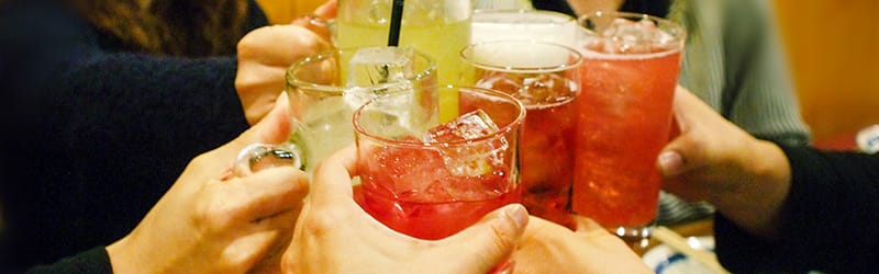 Image of people toasting with cocktails and having fun