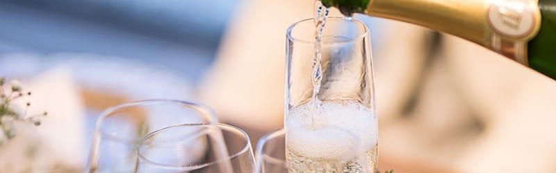 Image of champagne being poured into a flute-shaped champagne glass