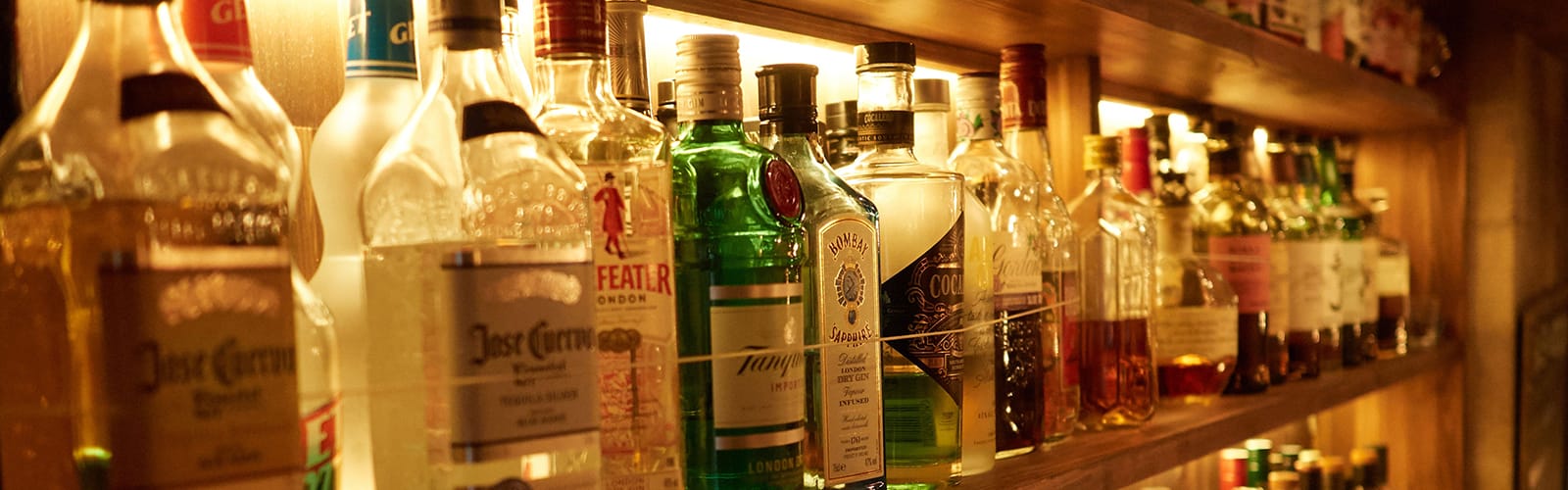 Shelves lined with bottles of various spirits and liqueurs